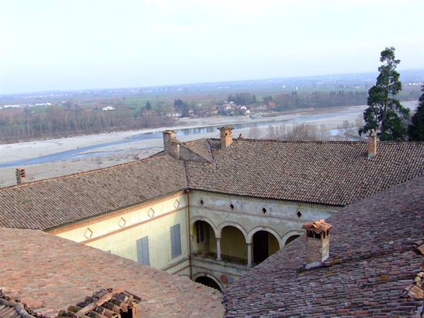 Terracotta rooftops of an arcaded palace above the Po river
