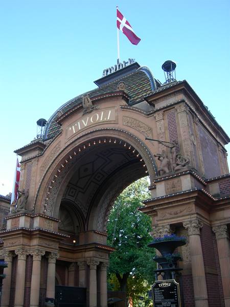 Brick Tivoli entrance arch with Danish flag, lights and blue sky