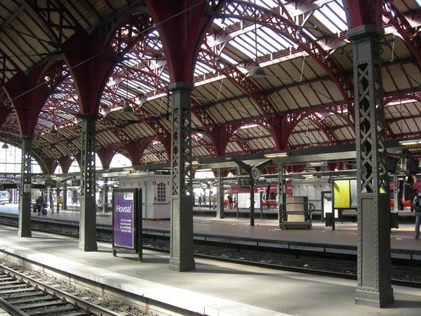 Tracks and platform under the red iron roof of Copenhagen Central Station