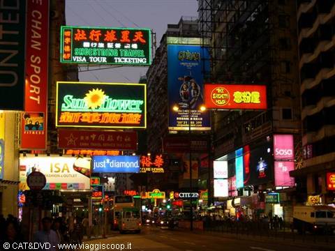 Bright neon signs in Hong Kong: colorful billboards, traffic and skyscrapers
