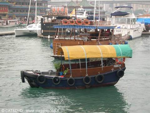 Wooden sampan with yellow-green canopy moored at Aberdeen harbour
