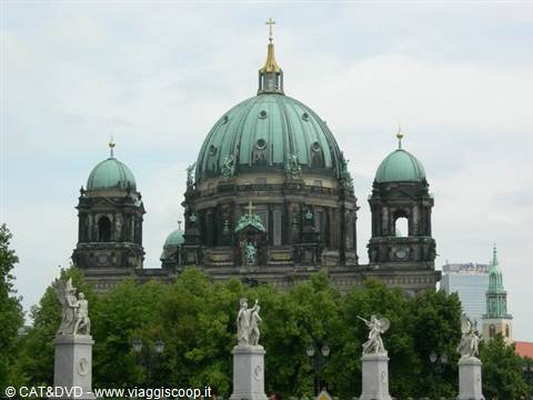 Green dome of Berlin Cathedral above marble statues on columns