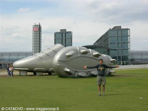 Tourist posing in front of the giant football boots, Frankfurt station