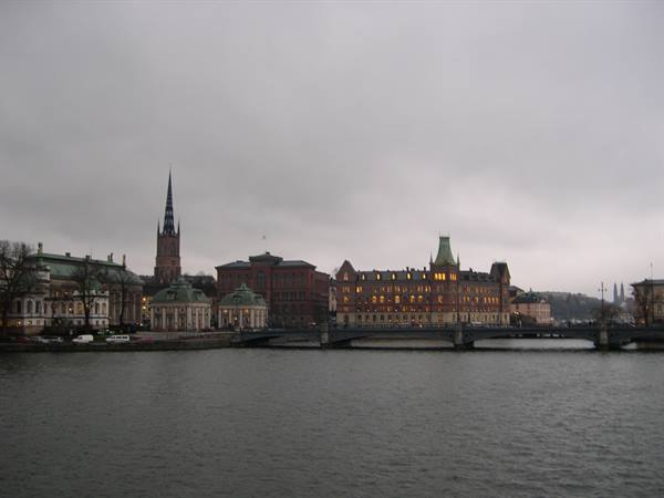 Riddarholmen in Stockholm, historic buildings and bridge over grey water