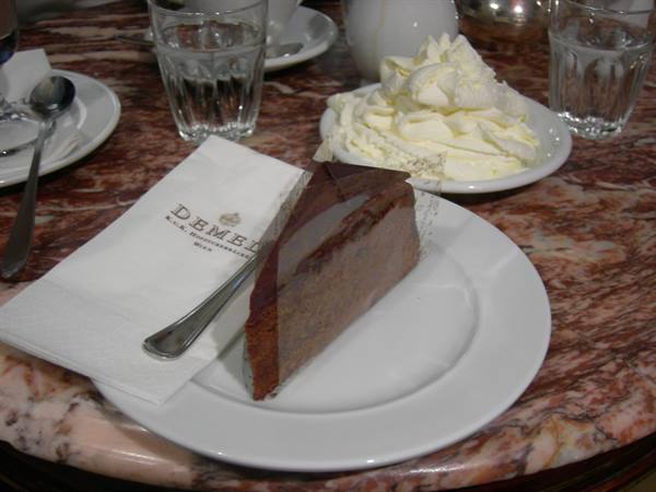 Chocolate cake with whipped cream on Demel's marble café table