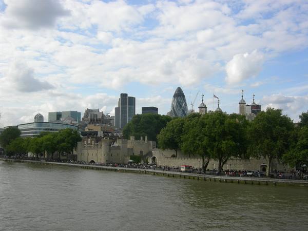 The Tower of London along the Thames with City skyscrapers