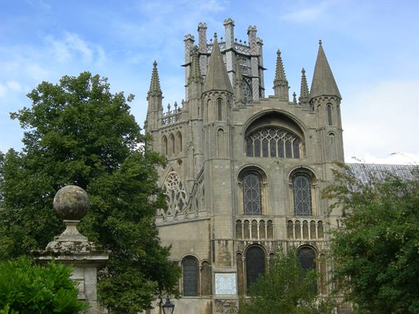 Gothic stone cathedral in Ely with spires and tall arched windows