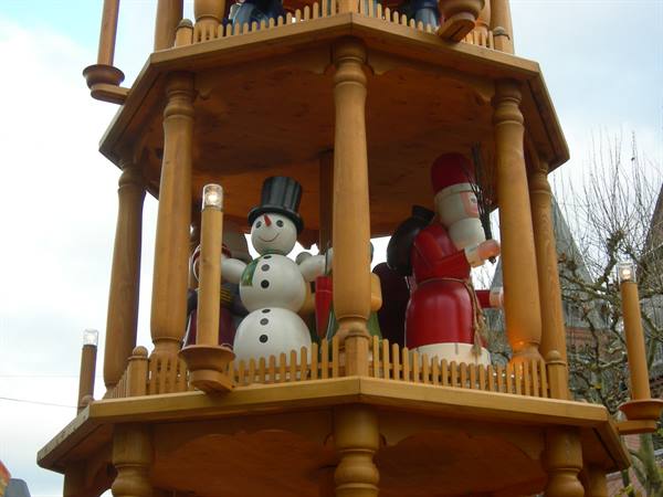 Wooden Christmas pyramid with snowman and Santa Claus figures