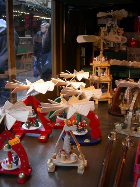 Handmade wooden pyramids and spinning ornaments displayed at a Christmas market