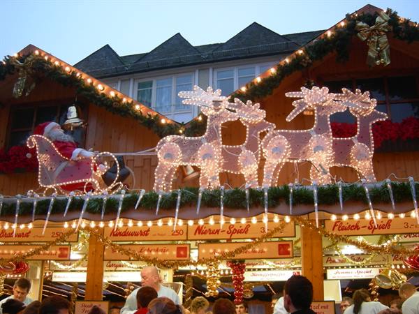 Christmas market: wooden stall with illuminated Santa sleigh and reindeer lights