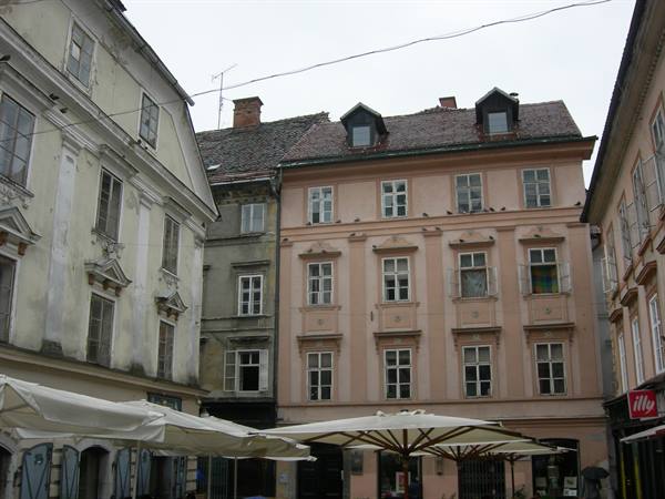 Pastel old buildings and white café umbrellas in Ljubljana's old town
