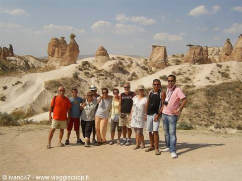 Group of tourists posing among fairy chimneys in Cappadocia