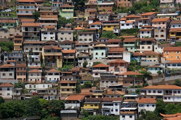 Colorful tiled-roof houses stacked on a steep hillside