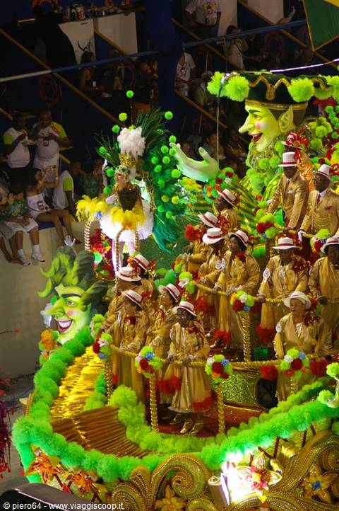 Rio Carnival: dancers in gold costumes on green allegorical float at the Sambódromo