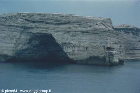 Limestone cliff with sea cave in Bonifacio, soft light over calm water