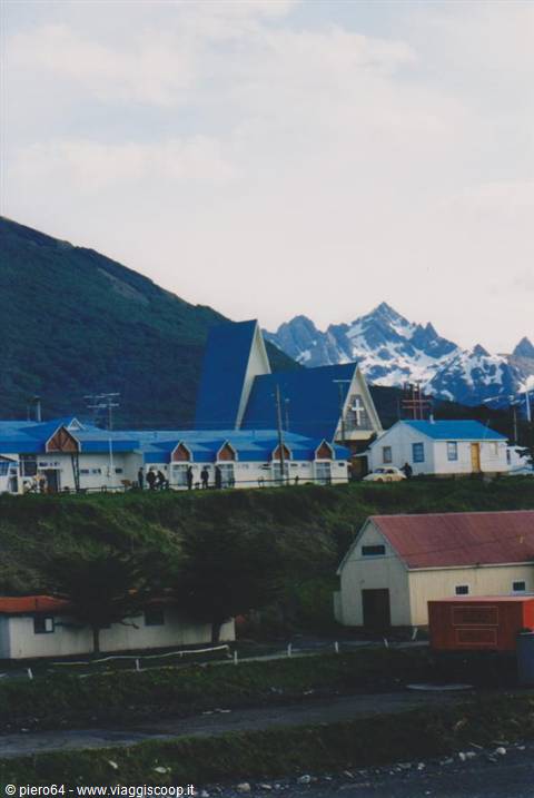 Blue-roofed church among houses and snowy peaks, Puerto Williams