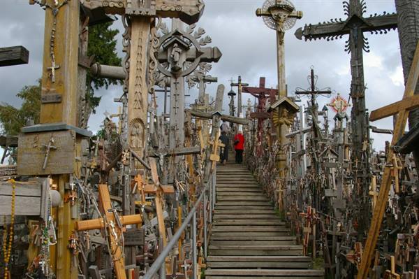 Thousands of wooden crosses surrounding the wooden stairway at the Hill of Crosses