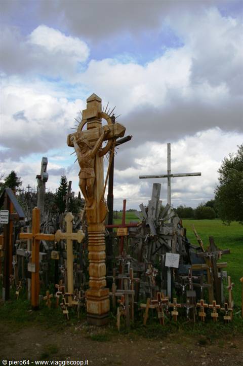 Carved wooden crucifix among hundreds of crosses at the Hill of Crosses