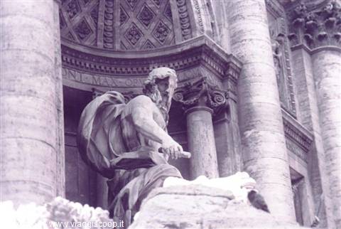 Marble Oceanus statue at Trevi Fountain among Baroque columns