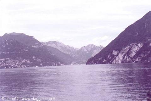Calm waters of Lake Como between mountains and shoreline villages