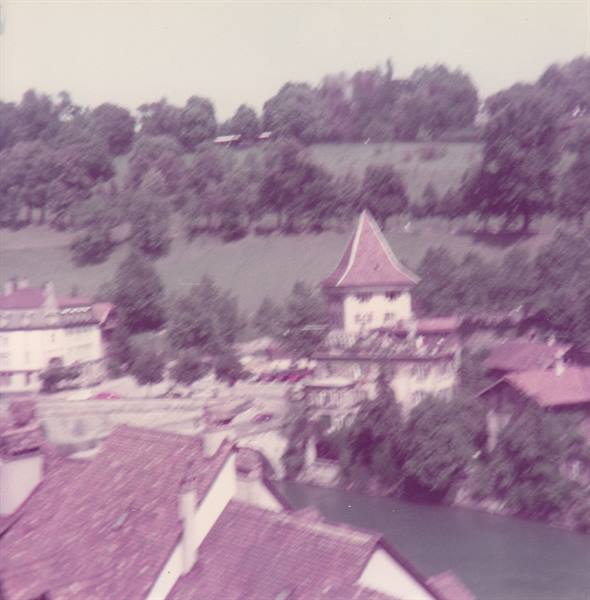 Red rooftops and pointed tower in Bern, Aare river, soft daylight