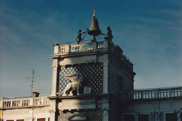 St Mark's Clocktower in Venice: golden winged lion and bell with two bronzes