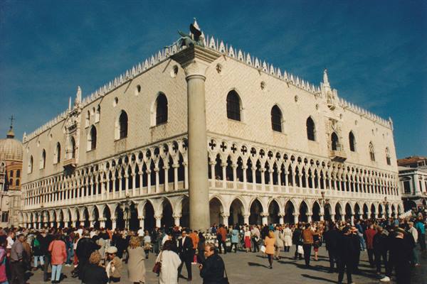 Doge's Palace in Venice, crowds of tourists under a blue sky