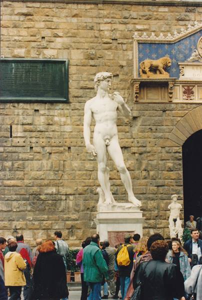 Marble copy of Michelangelo's David, crowded tourists at Piazza della Signoria, Florence