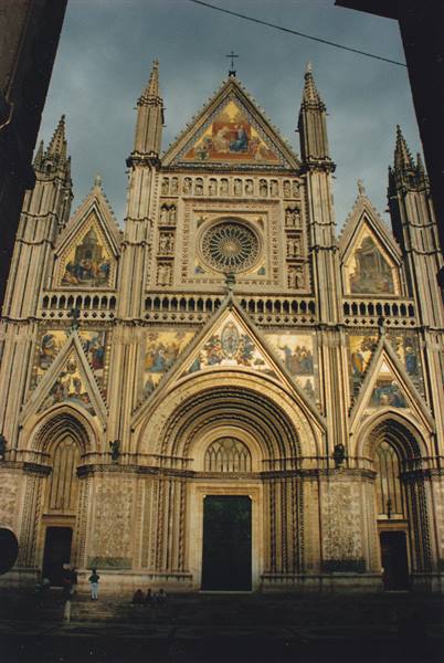 Gothic facade of Orvieto Cathedral with golden mosaics and rose window