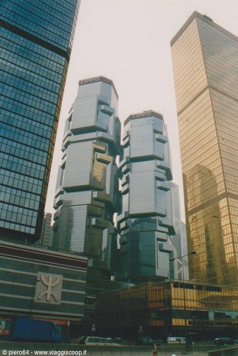 Reflective glass twin towers in Hong Kong, surrounding skyscrapers and street traffic