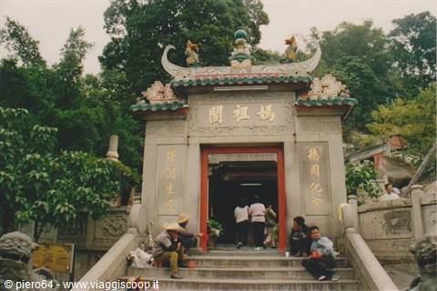 A-Ma Temple in Macau: stone gateway with golden inscriptions, visitors on the steps