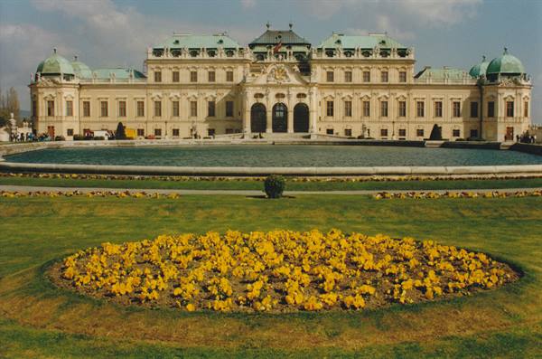 Belvedere Palace in Vienna with yellow flowerbeds and reflecting pool in front