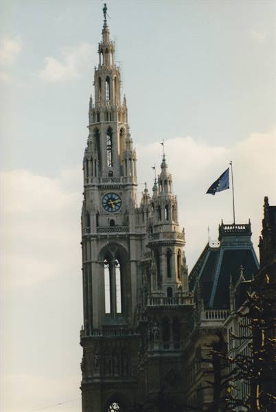 Gothic tower of Vienna Rathaus with clock and EU flag