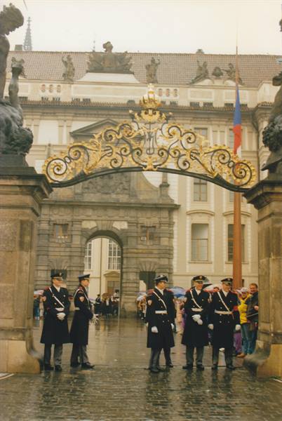 Ceremonial guards under the golden wrought-iron gate of Prague Castle