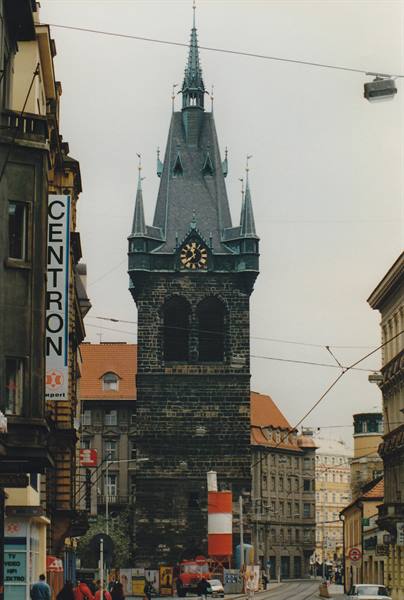 Jindřišská věž tower in Prague rising among city buildings and tram wires