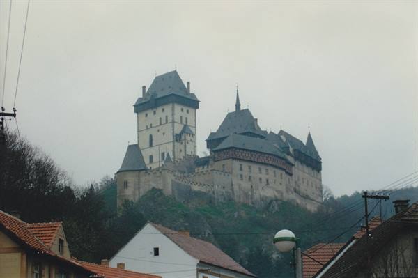 Karlštejn Castle gothic towers on the hill above red-roofed houses