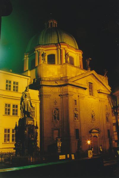 Charles IV statue before the domed baroque church, Prague at night