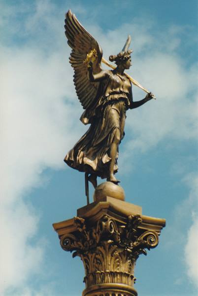 Bronze winged angel holding a wreath atop the Siegessäule column in Berlin