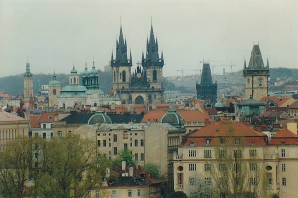 Týn Church and Prague rooftops under grey sky