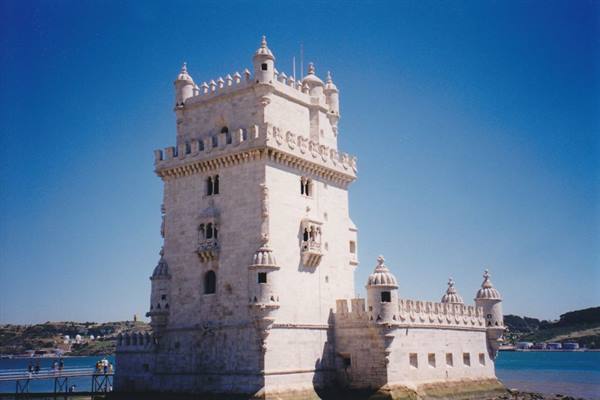 Belém Tower in pale stone on the Tagus river in Lisbon, blue sky