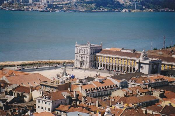 Praça do Comércio in Lisbon, yellow buildings by the Tagus, red rooftops