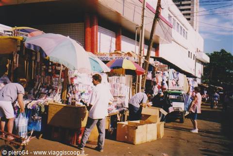 Street market with colorful umbrellas, vendor stalls and shoppers, Ciudad del Este