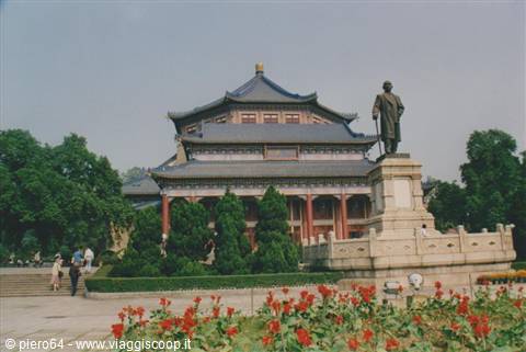 Sun Yat-sen statue in front of the Memorial Hall in Guangzhou, red flower beds