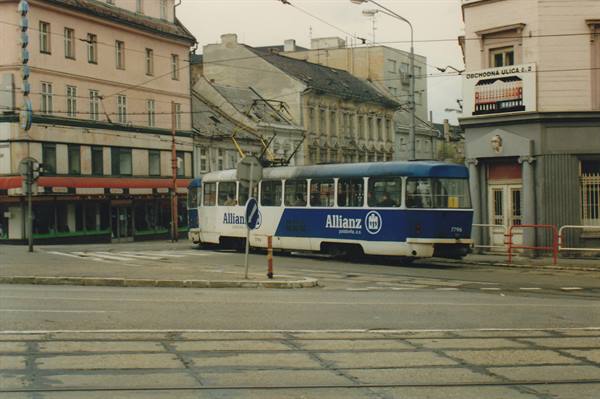 Blue Allianz tram crosses the intersection among historic buildings in Olomouc