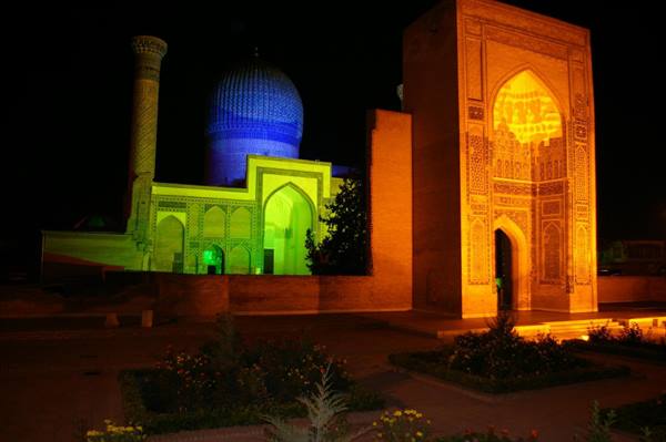 Gur-e Amir mausoleum in Samarkand lit green and blue at night