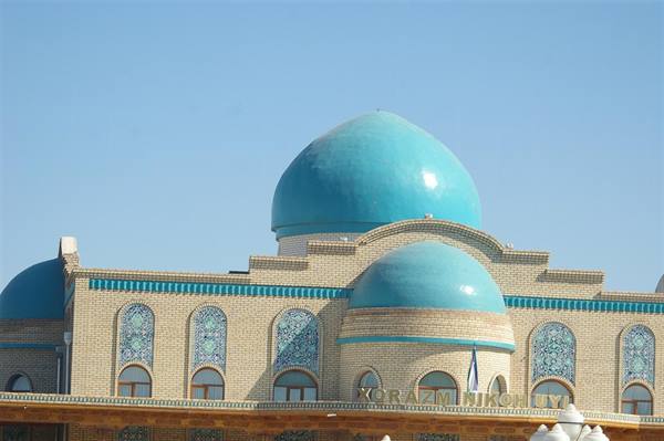 Turquoise domes over light brick facade with blue tile decorations, Khorezm Nukhuiya