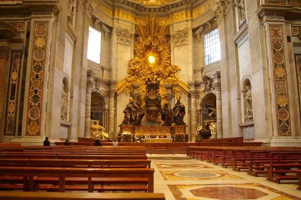 St. Peter's Basilica: Bernini's gilded Cathedra above the altar, among wooden pews