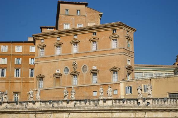 Ochre brick building with statues on the balustrade, Vatican City