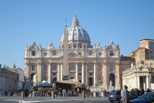 St Peter's Square with Egyptian obelisk and basilica under blue sky