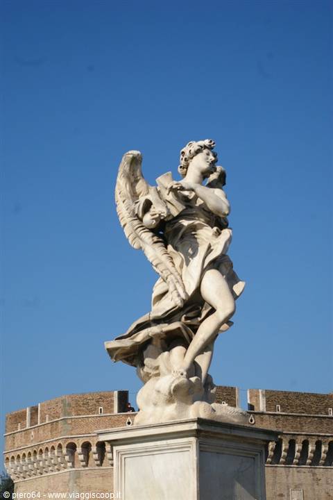 Marble angel statue holding a frame on Sant'Angelo Bridge, Rome, blue sky